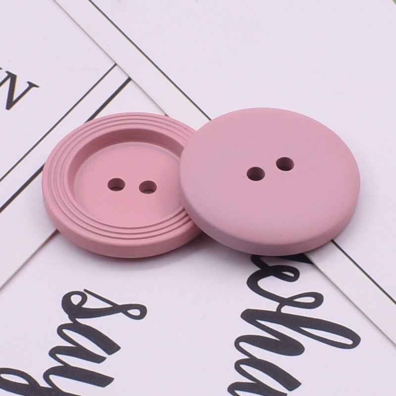 Round 2-hole resin buttons in light pink, 25mm for crafts and garment closures