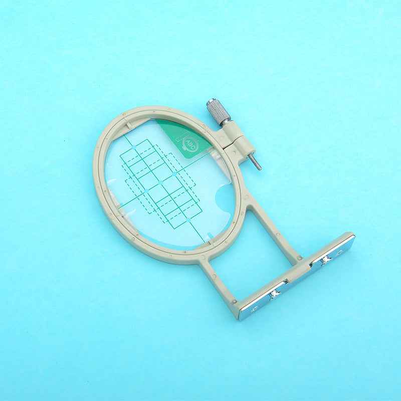 Oval embroidery hoop with clamping bracket and adjustable mounting screw