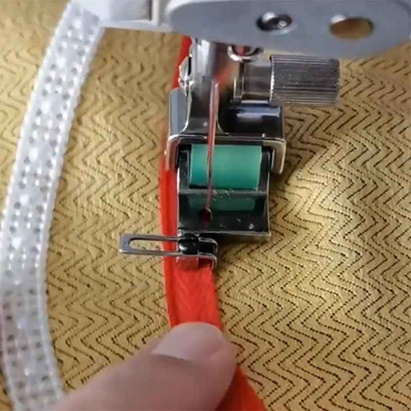 X6 rolled hem foot sewing a folded edge with green guide roller on fabric
