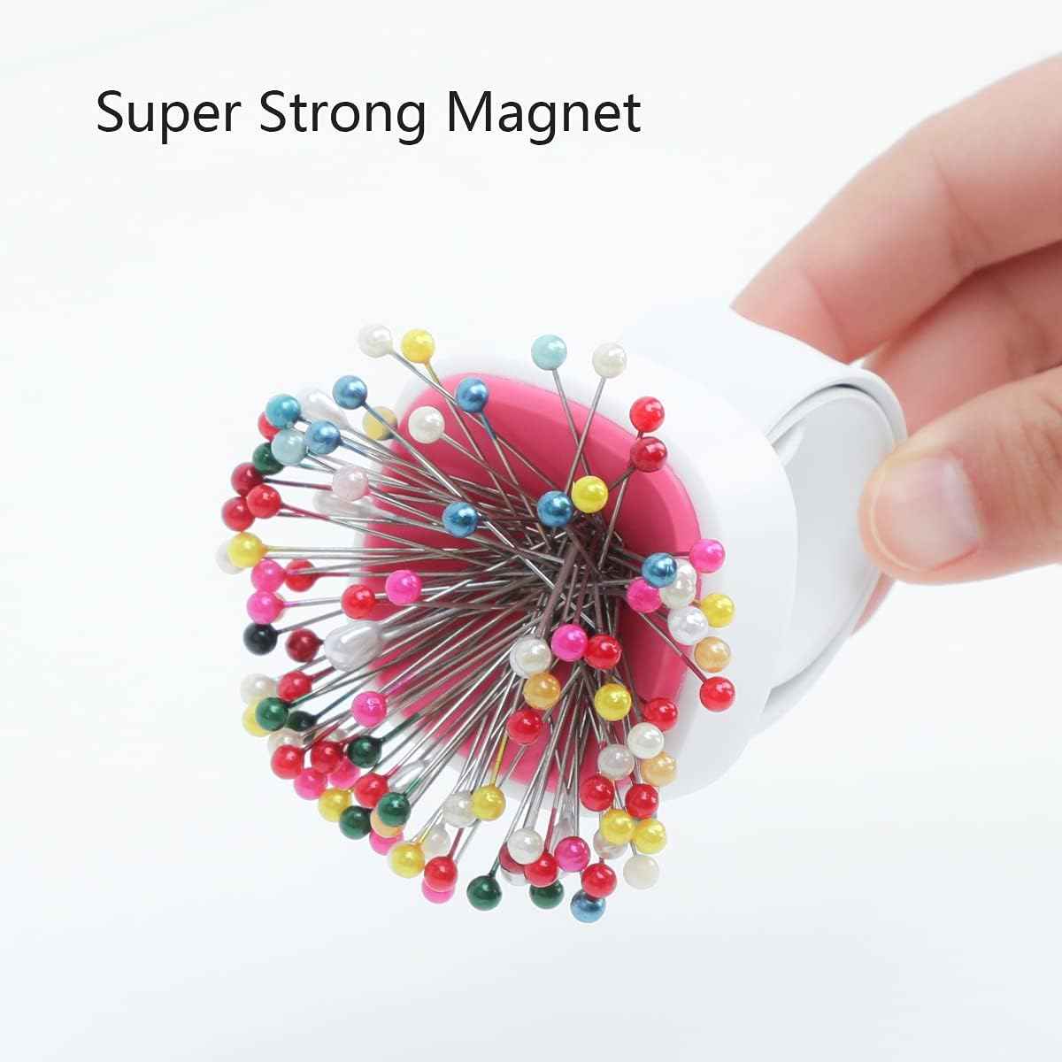 Magnetic wrist pin cushion with colorful sewing pins attached to a pink pad on white band.