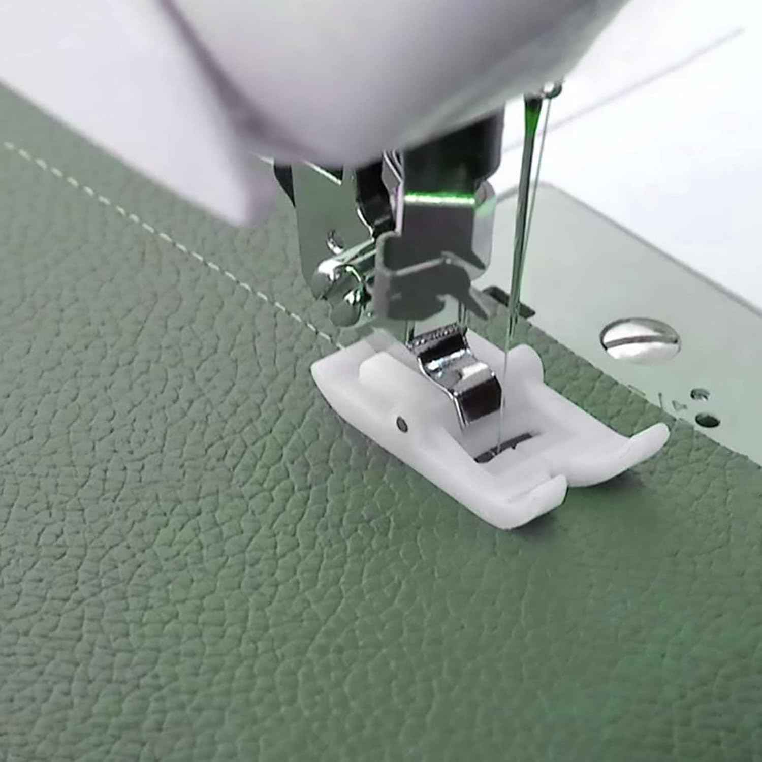White roller presser foot attached to sewing machine, ready to stitch