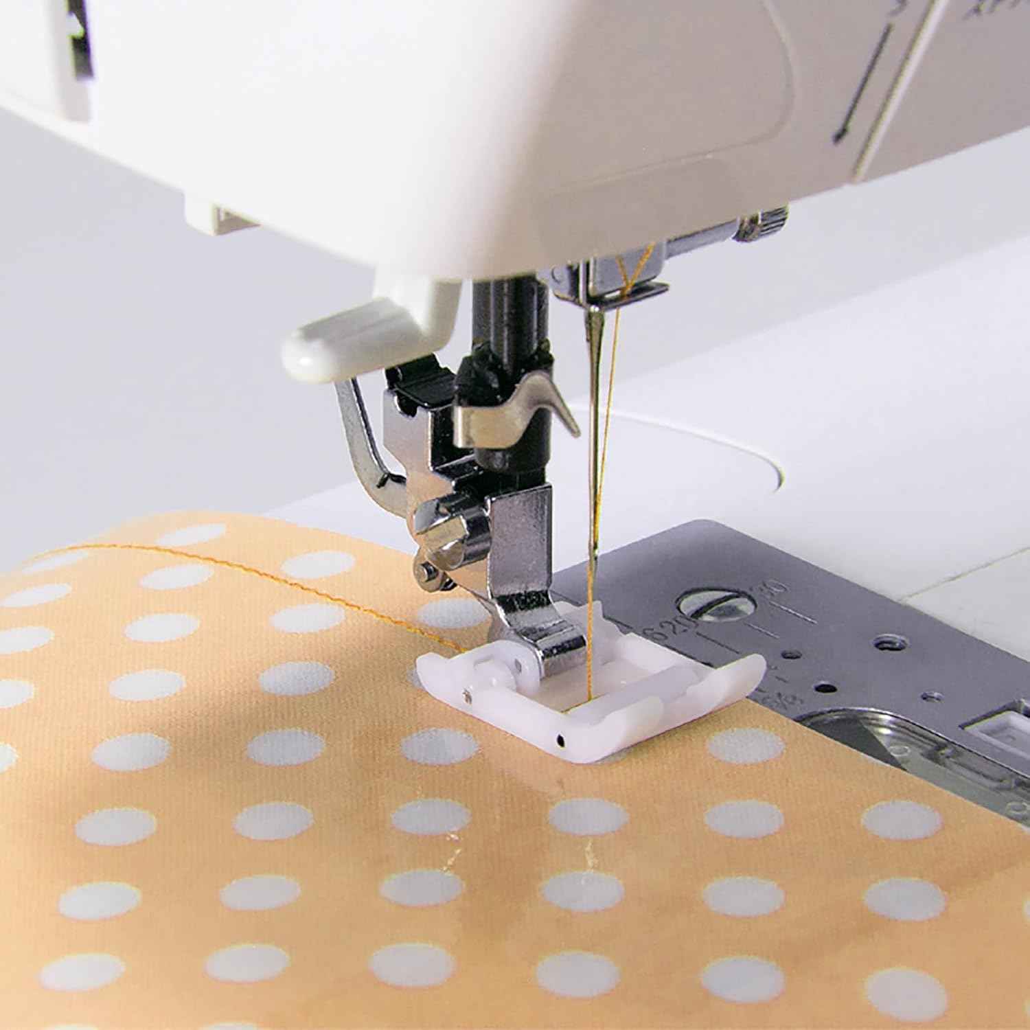 Teflon roller foot on sewing machine, white base under presser area