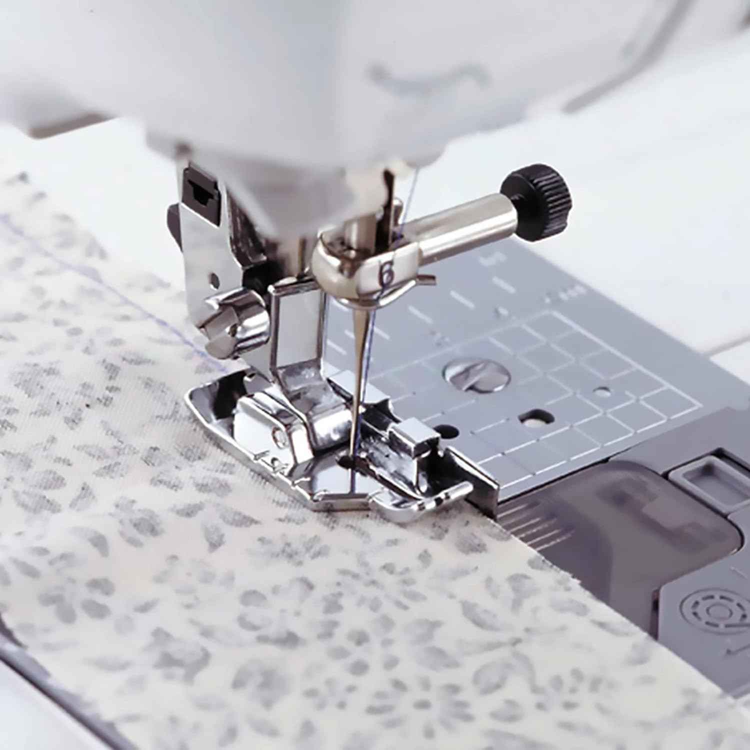 1/4-inch quilting presser foot in use on fabric with sewing machine needle
