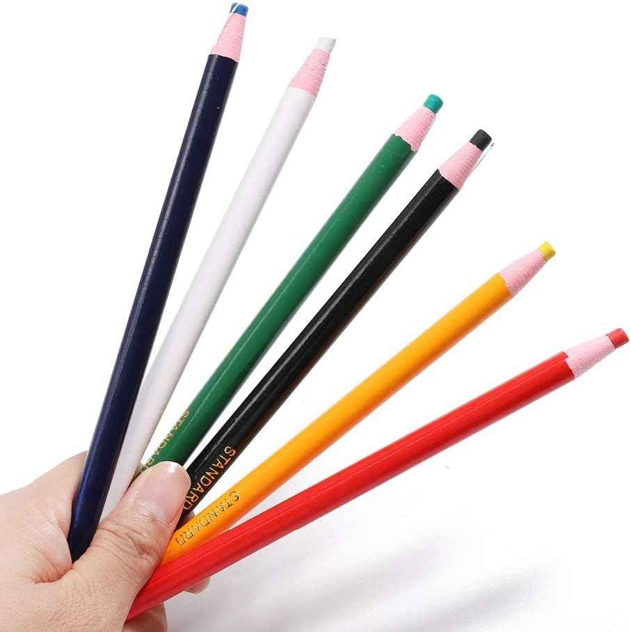 Set of sewing marking pencils held in a hand, pink tips with blue, green, yellow, and red ends