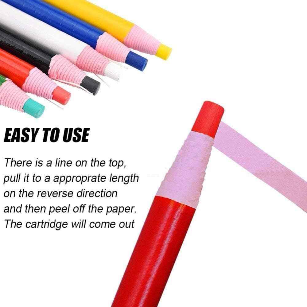 Close-up of sewing marking pencils with pink paper tips and colored end caps