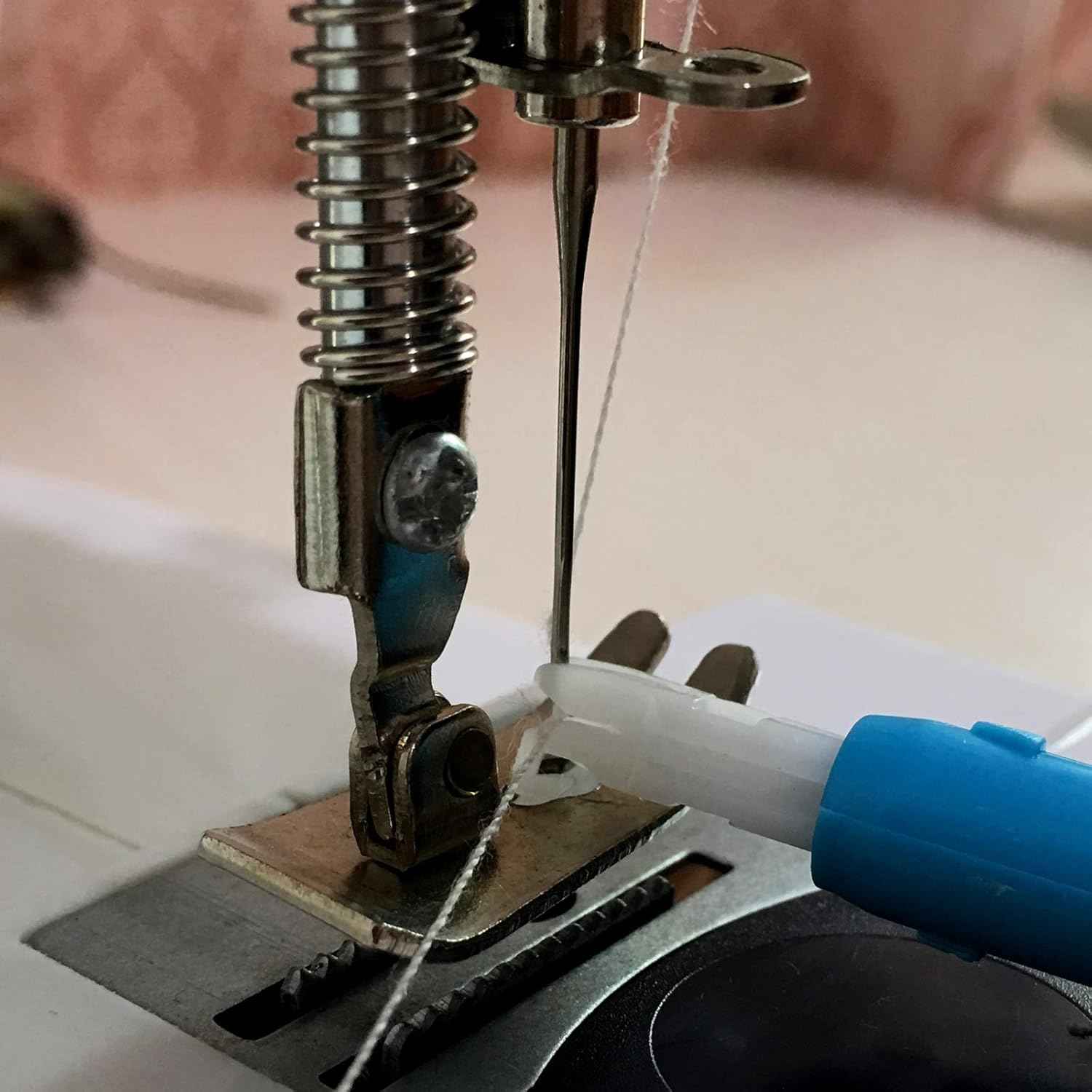 Sewing machine needle with automatic threader positioned at the needle eye.