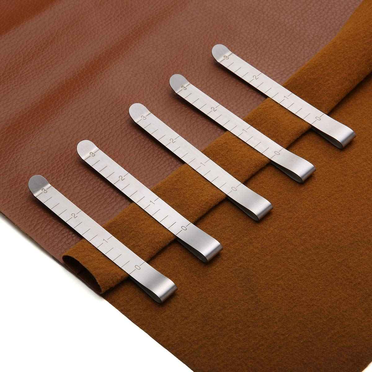 Five stainless hemming clips on fabric with visible measurements and snap-on curved tips