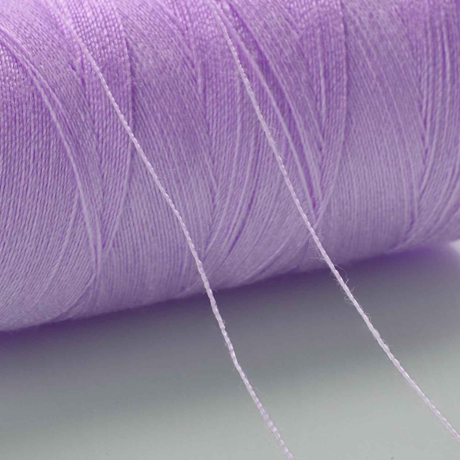 Light purple sewing thread close-up wound on a spool