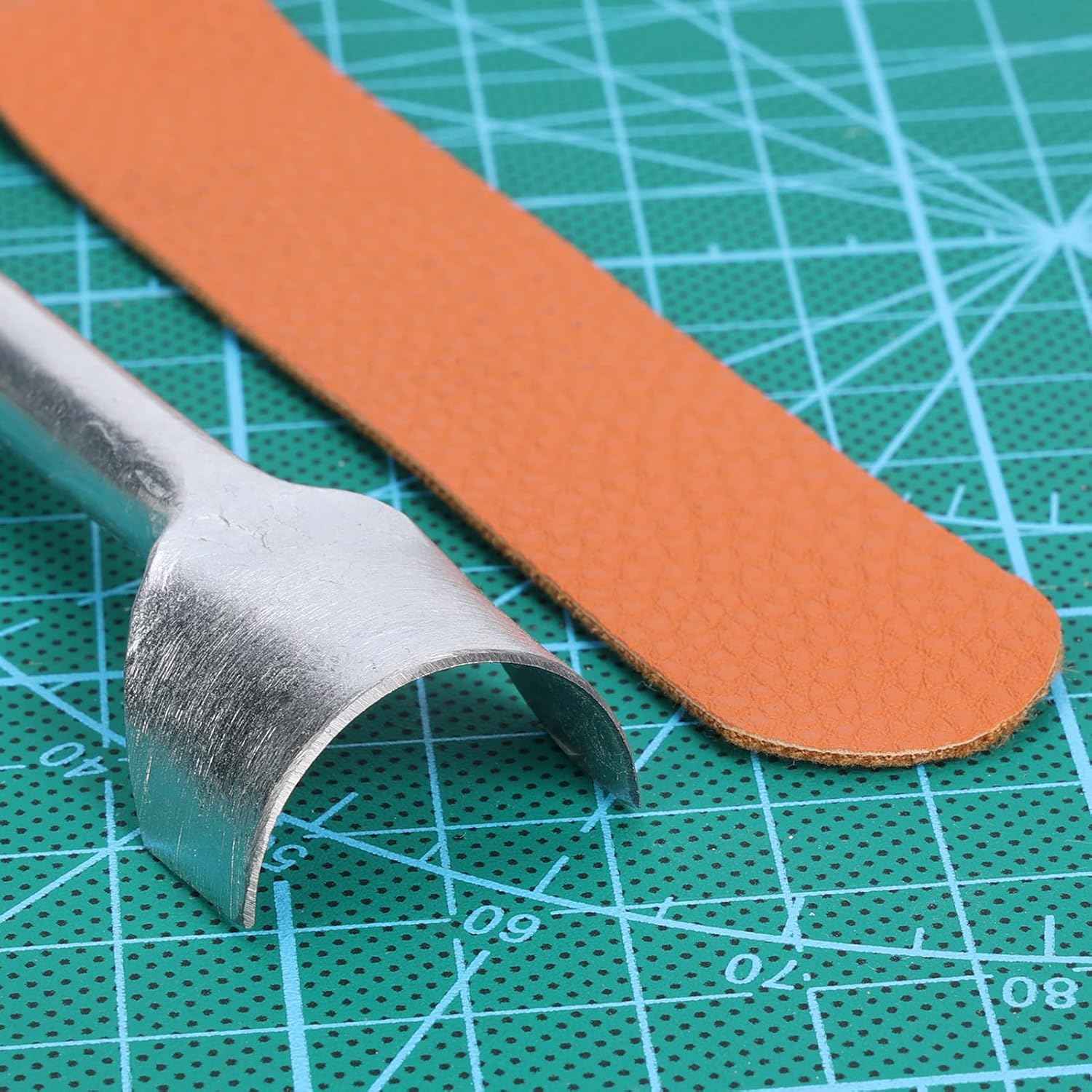 Half-round leather edge cutter punch cutting a curved leather piece on a mat