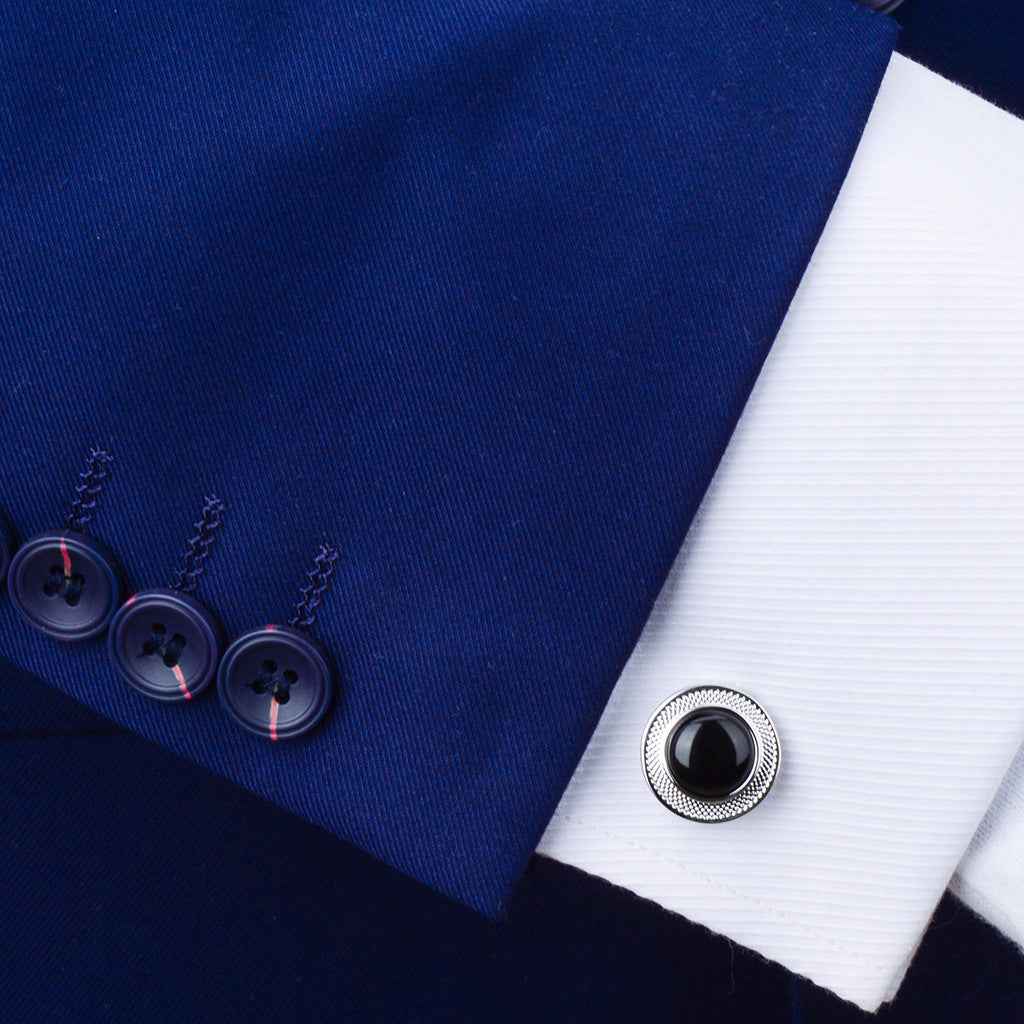 Round onyx cufflink with black stone and engraved floral textured border on cuff