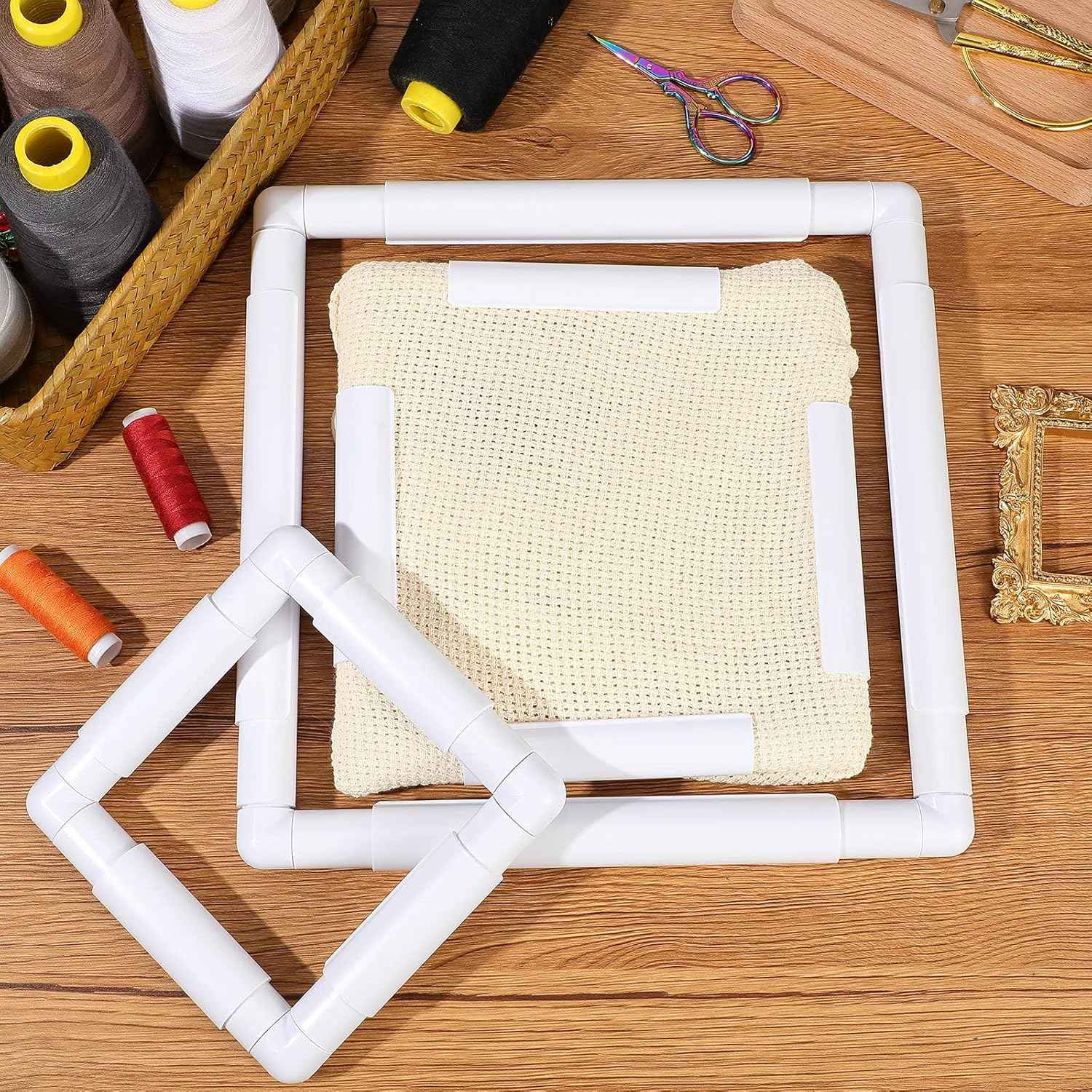 White embroidery hoop frame with cross-stitch cloth secured inside
