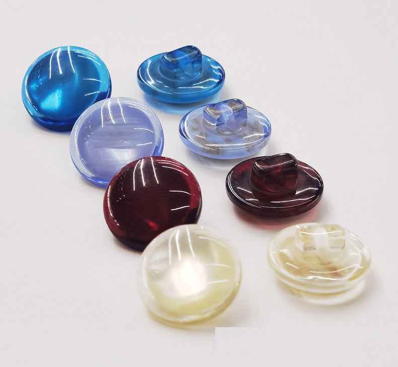 Colorful domed resin shank buttons: blue, clear, dark red, and cream