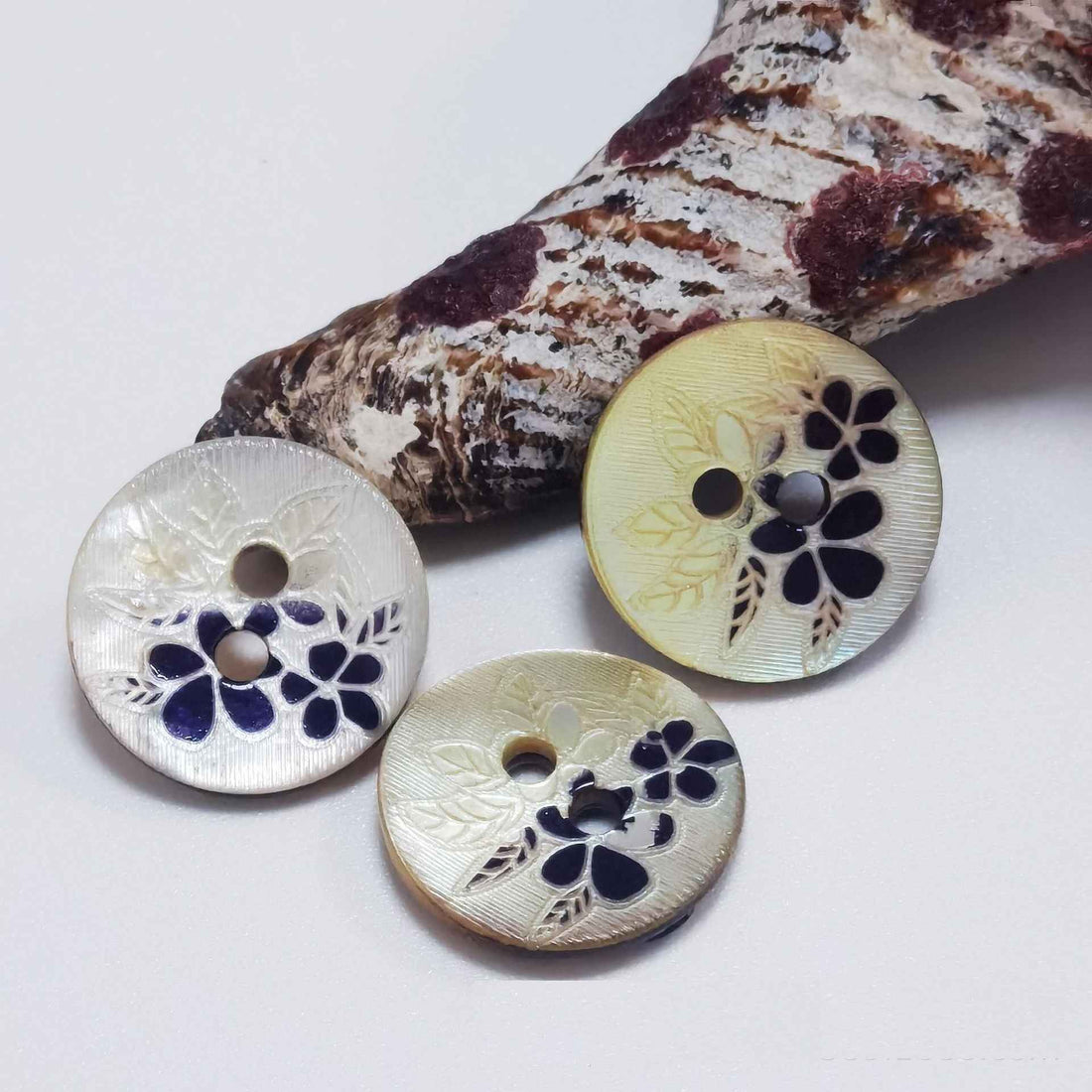 Mother-of-pearl 2-hole craft button set: cream floral inlay and dark mottled button, 2 holes.