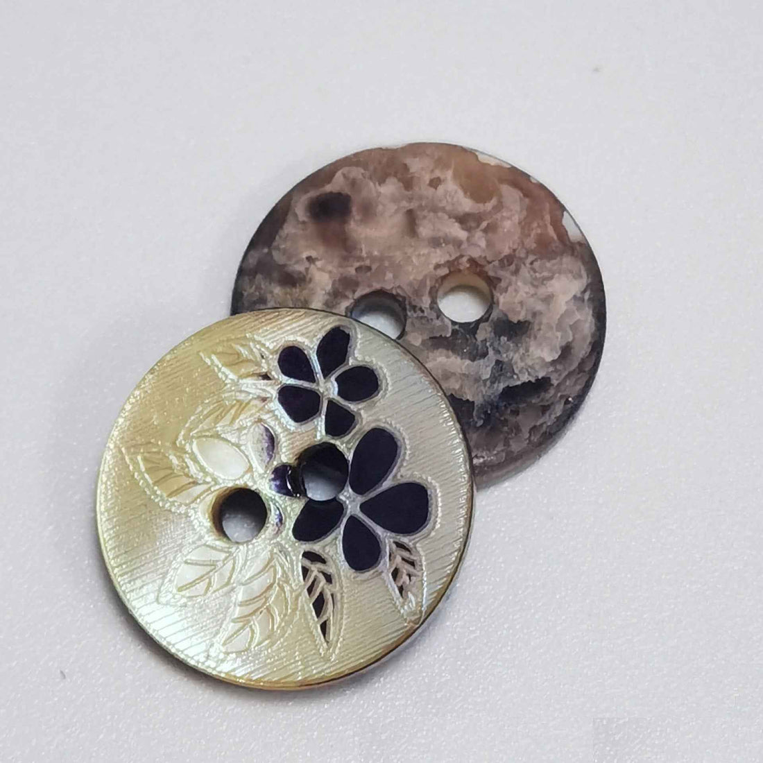 Mother-of-pearl 2-hole craft button set: cream floral inlay and dark mottled button, 2 holes.