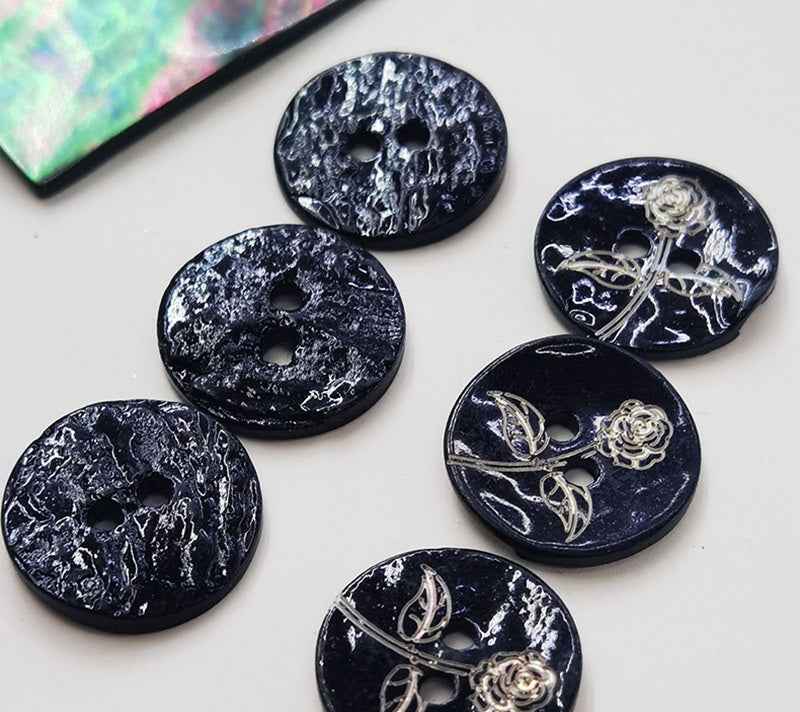 Multiple black printed mother-of-pearl shell buttons, rose-and-vine, two holes