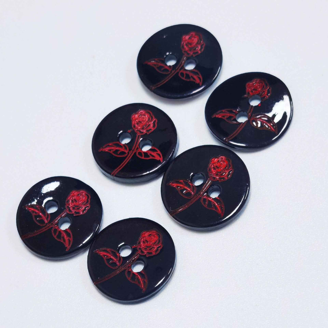 Set of round black shell-look buttons with red rose-and-vine floral print, 2 holes