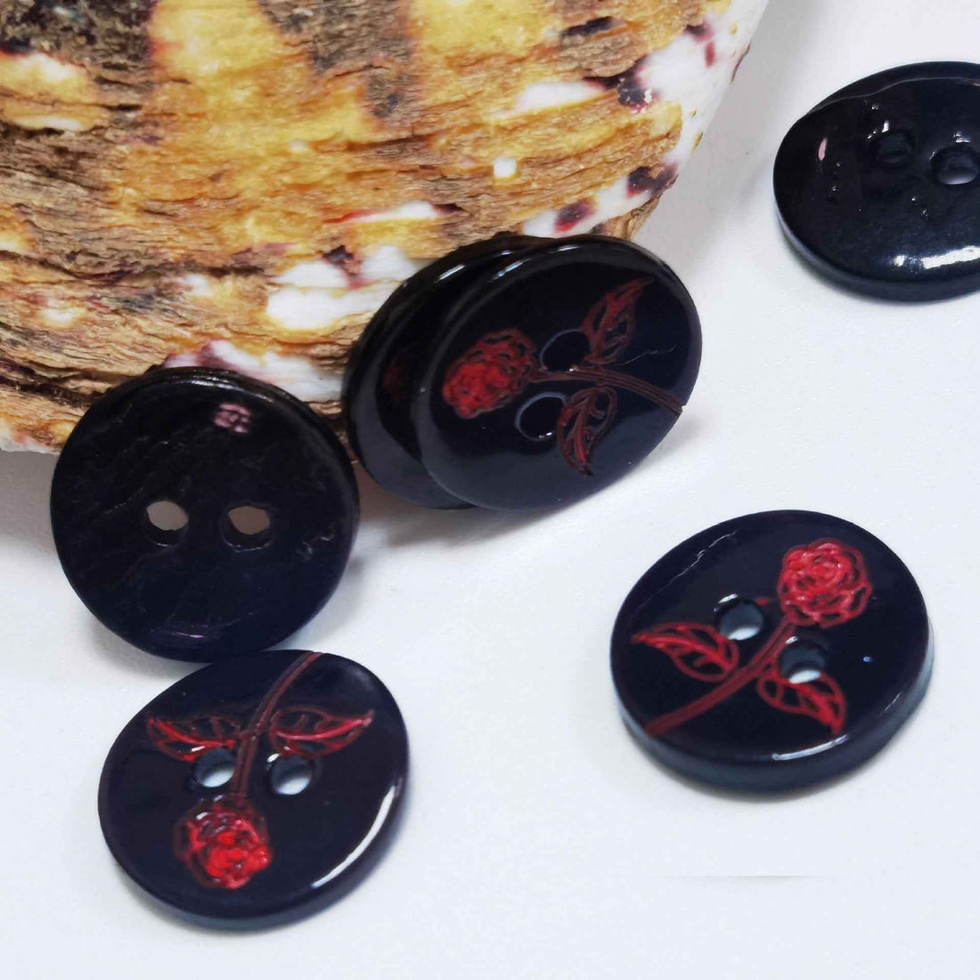 Set of round black shell-look buttons with red rose-and-vine floral print, 2 holes