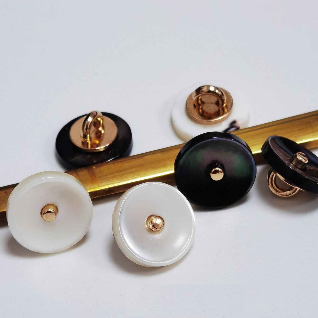 Ivory & black mother-of-pearl shank buttons, gold-tone backs, 5 buttons shown