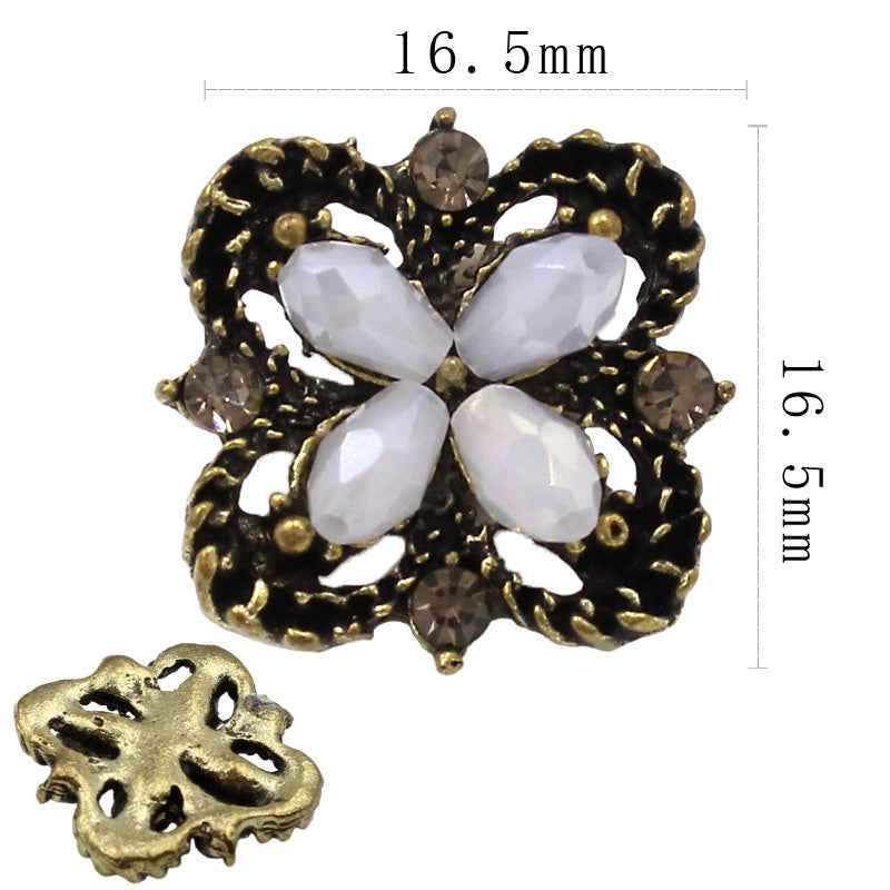 Black filigree flower shank button with white pear drops and smoky stones