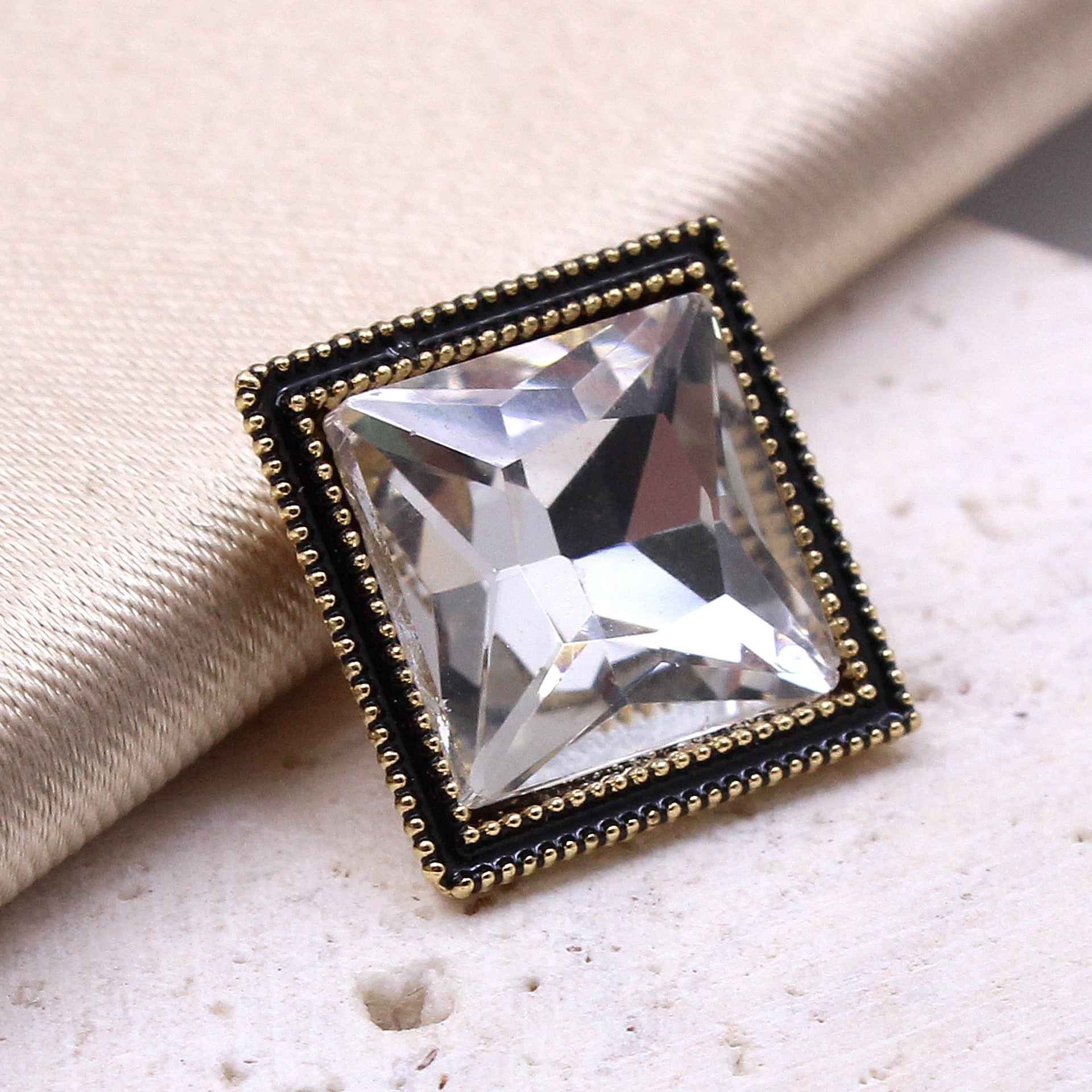 Square crystal shine glass button, black frame with gold trim and clear faceted crystal