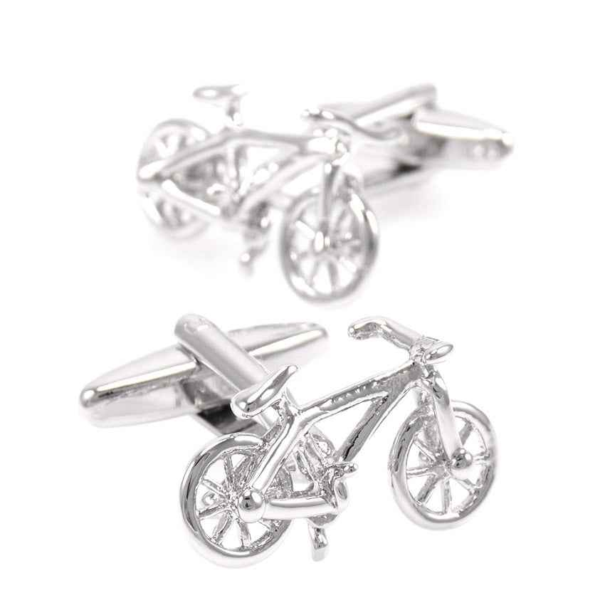 Polished steel bicycle-shaped cufflinks, front wheels and handlebars visible