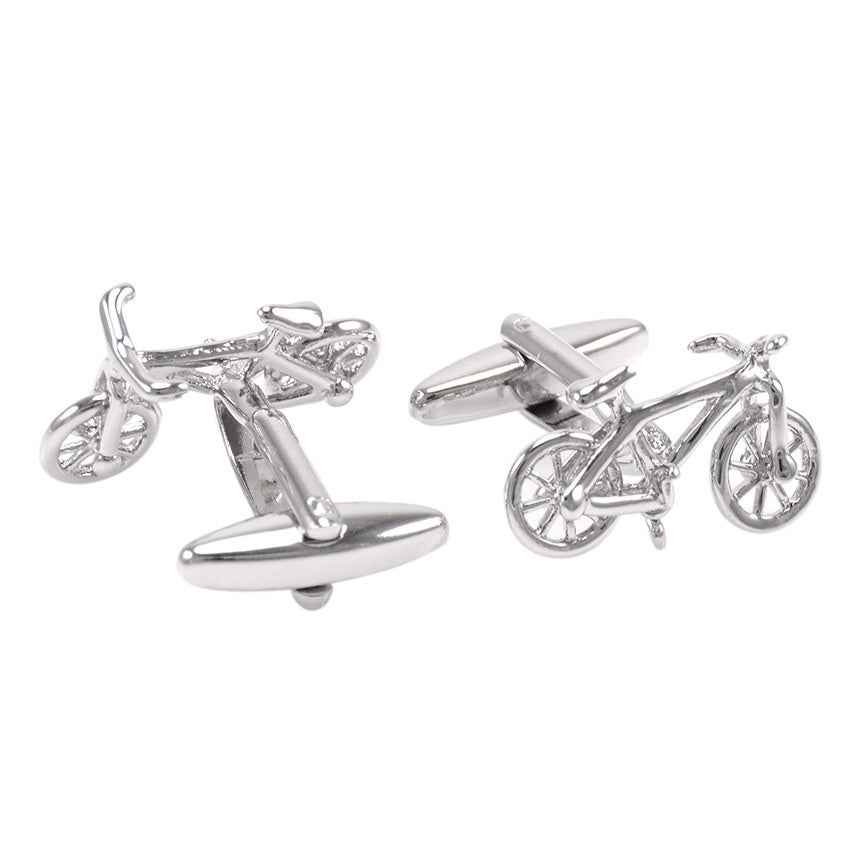Polished steel bicycle-shaped cufflinks, front wheels and handlebars visible
