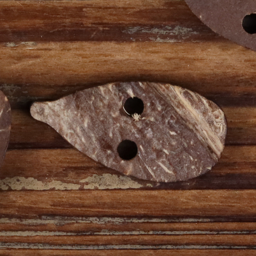Coconut shell novelty button with two holes in an irregular leaf-like shape