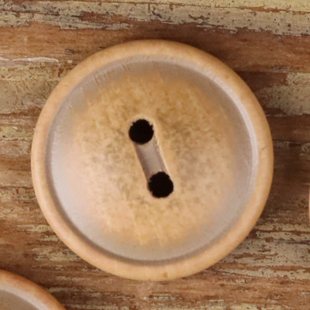 Round light tan wood 2-hole button with two dark holes, close-up