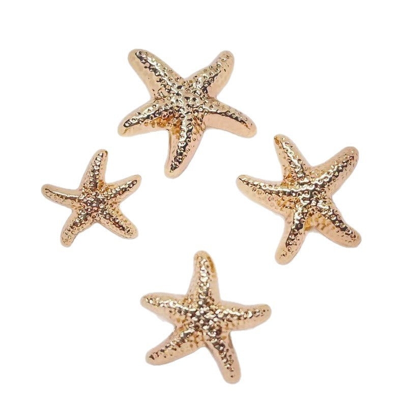 Gold starfish metal shank buttons with glittery textured surface, four-point sea stars