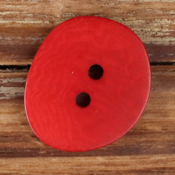 Red natural 2-hole button with two stitched holes, round irregular shape.