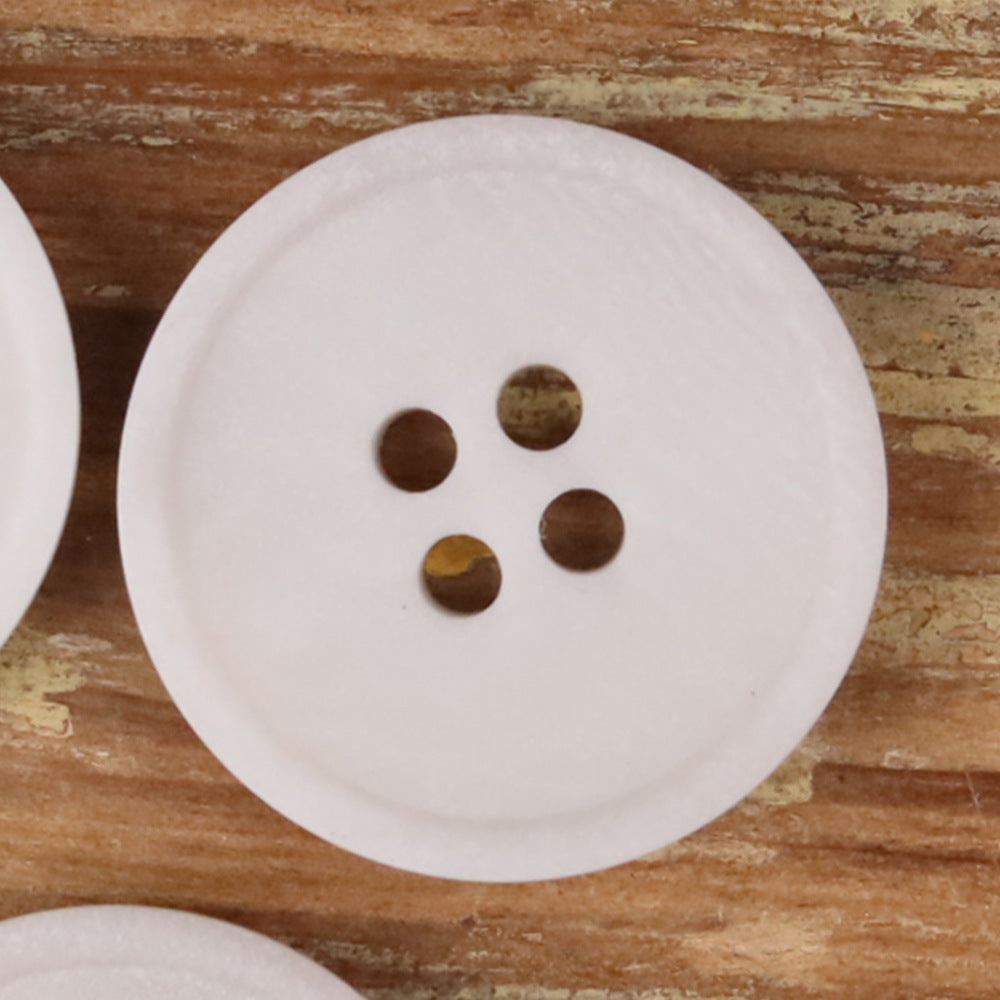 White round 4-hole matte natural nut button with four brown holes