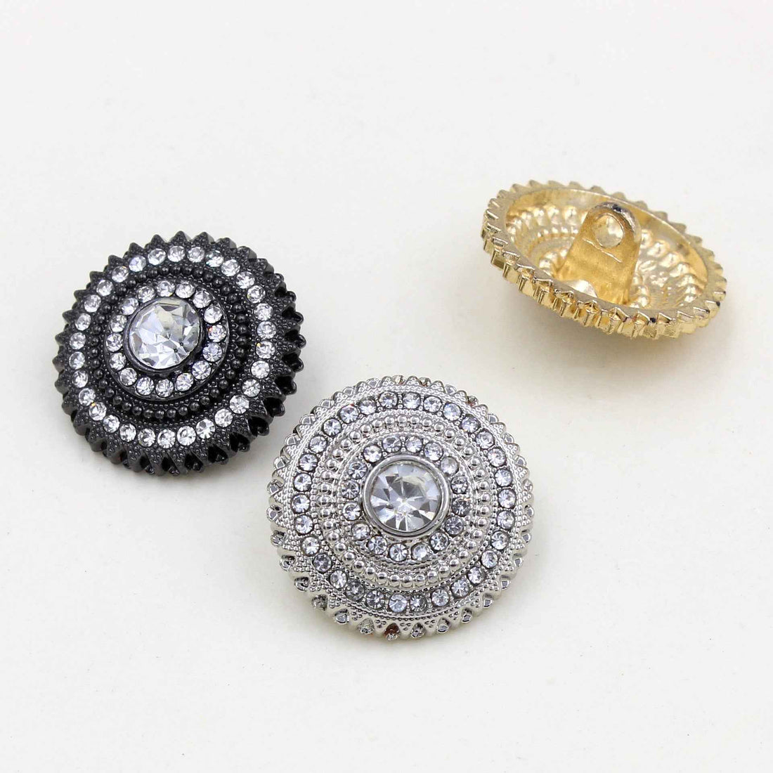 Round metal shank buttons set: silver, black, and gold rhinestone centers