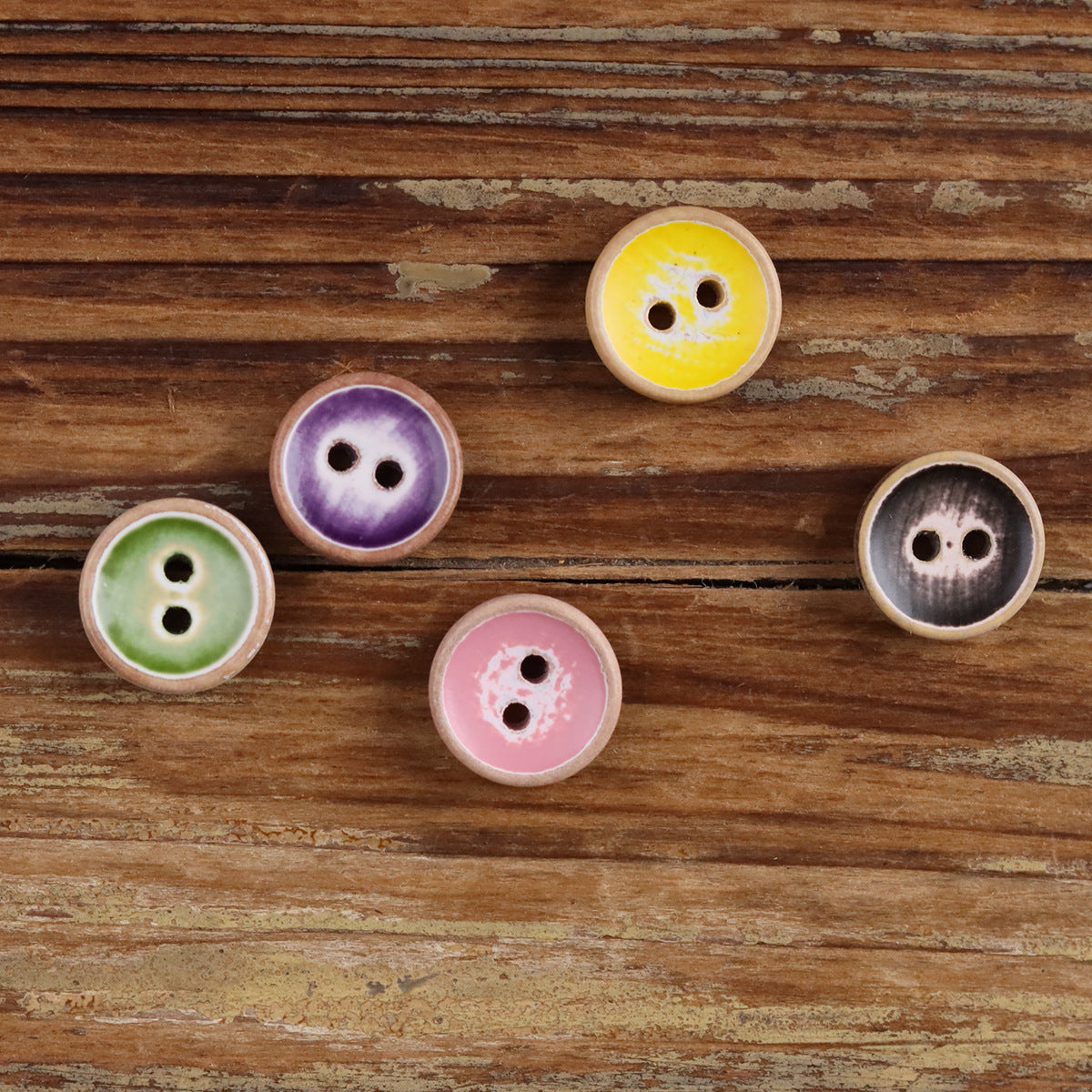 Round iridescent wood button, pale yellow, two holes