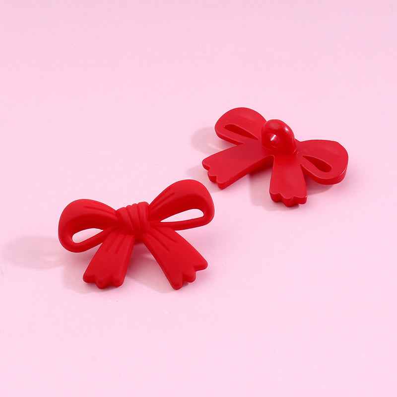 Red bow-shaped plastic shank buttons with loop shanks, 2-piece view