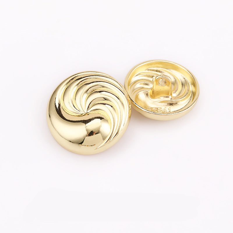 Silver spiral textured round metal shank button, front with decorative swirl pattern