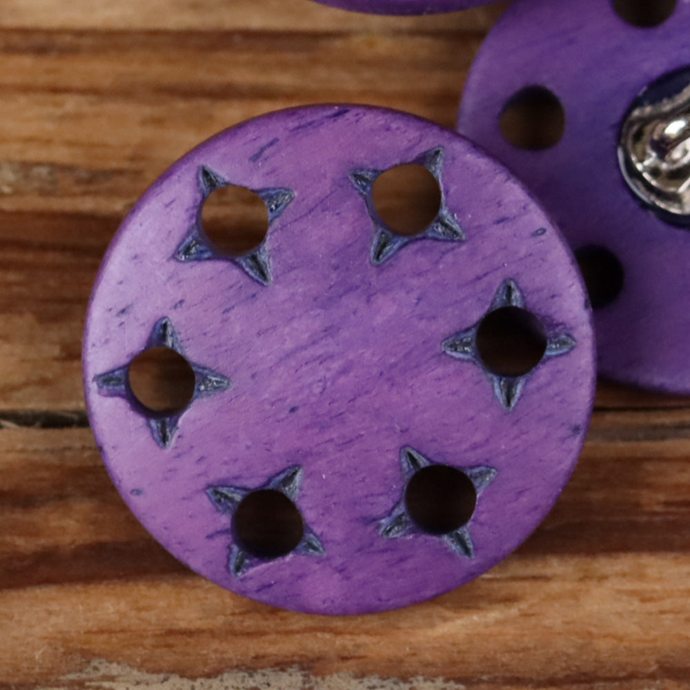 Purple star-cutout horn shank button with metal shank and star-shaped cutouts