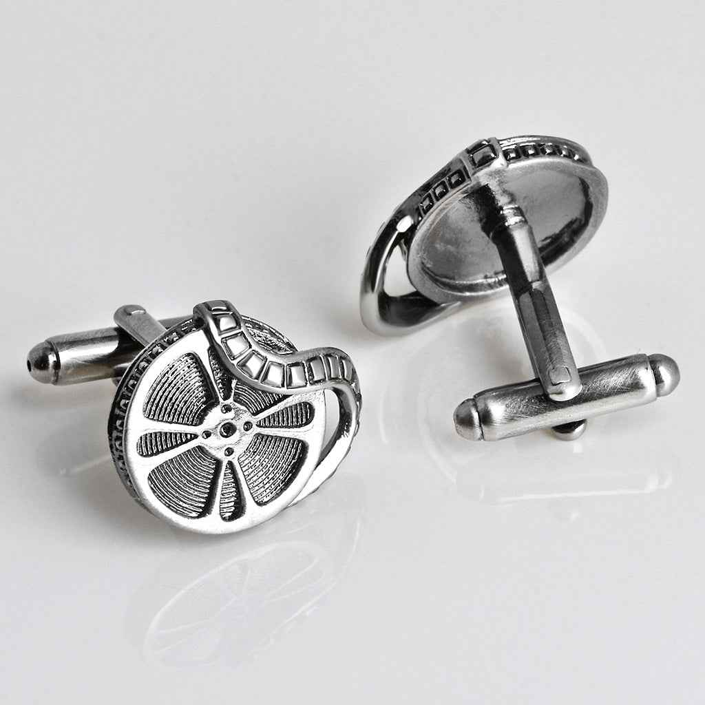 Vintage film projector cufflinks in antique silver, round reels with textured fan blades