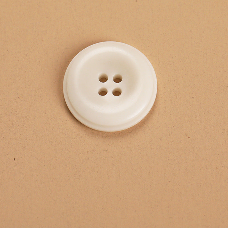 Round 4-hole natural fruit shell button, off-white, front view