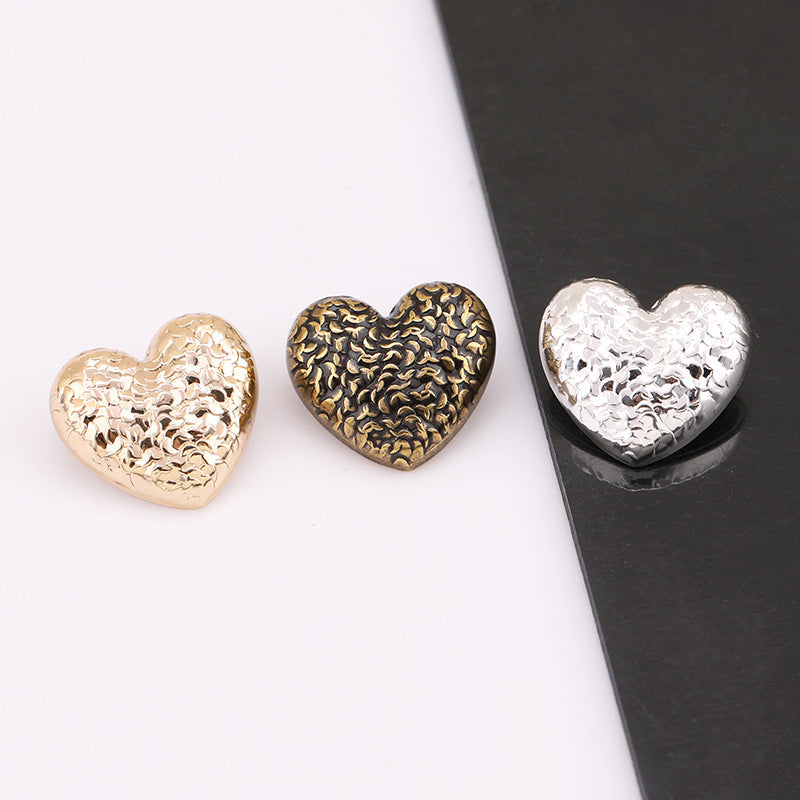 Heart-scale metal shank button, antique gold; underside stamped '0130'