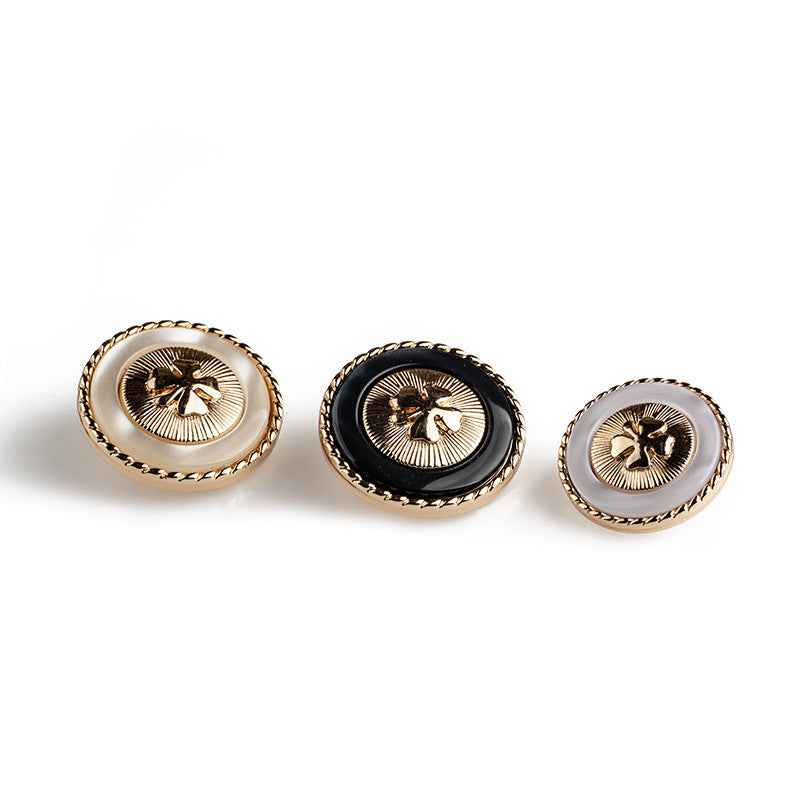 Mixed button set: black, white, and beige four-leaf clover designs with gold borders