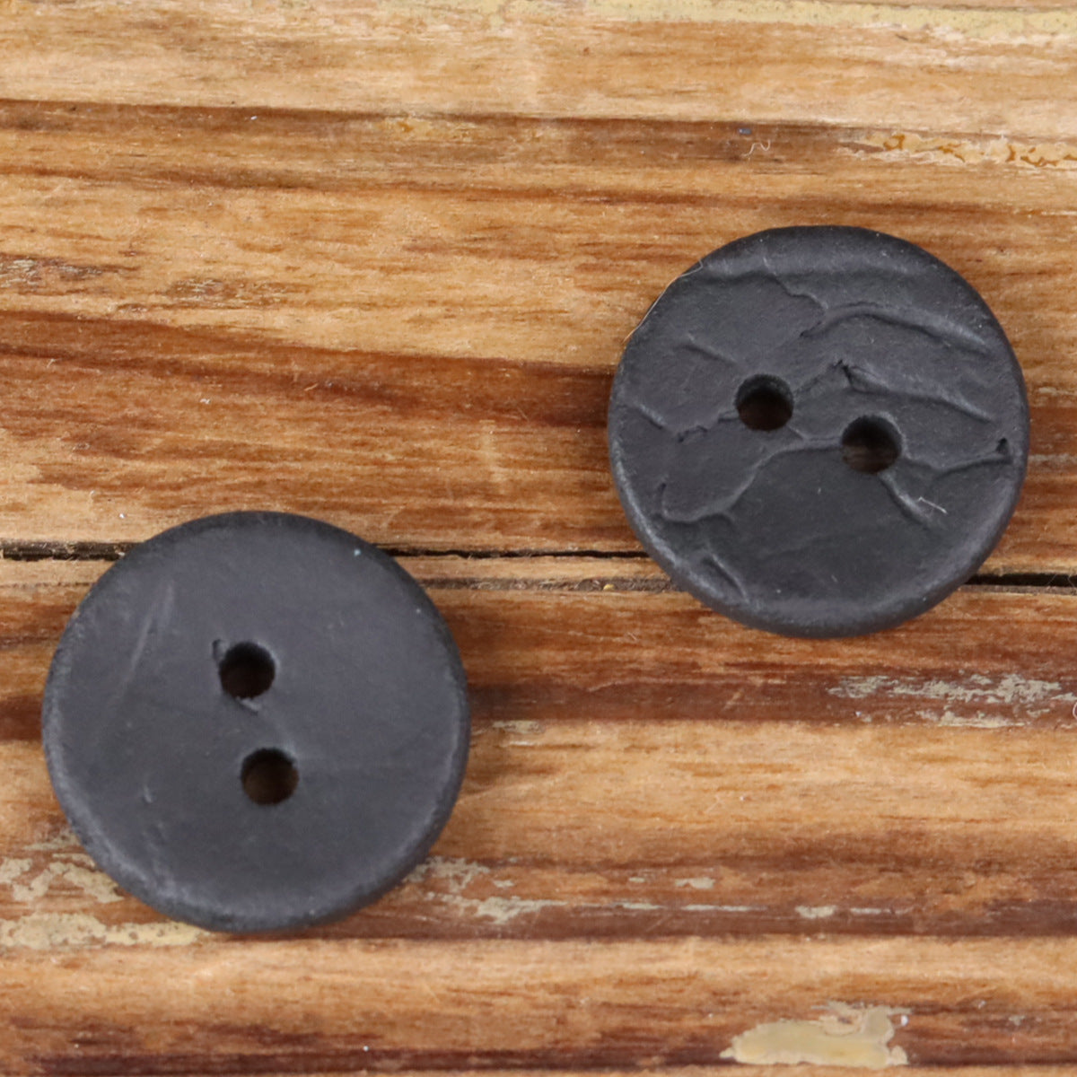 Round 2-hole dark coconut shell buttons, two front views