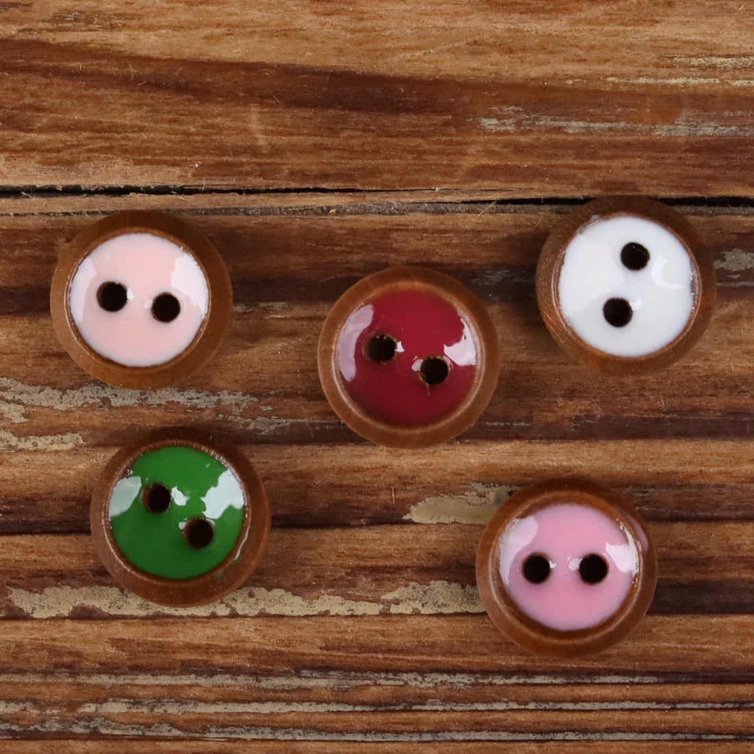 Round 2-hole wood shirt button with green resin front and natural wood edge
