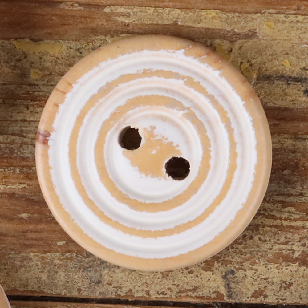 Round 2-hole wood button with white and cream double rings, worn finish