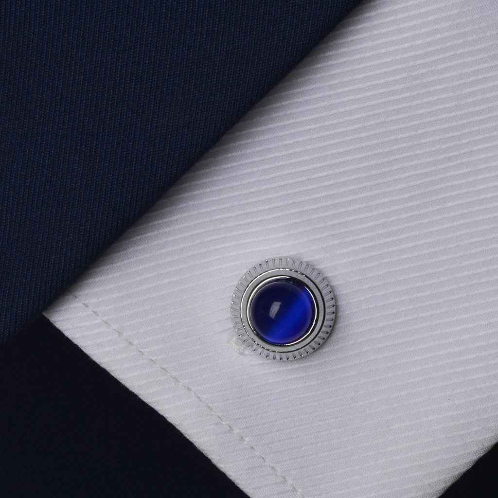 Blue cat’s eye round cufflink on shirt cuff with silver ridged edge