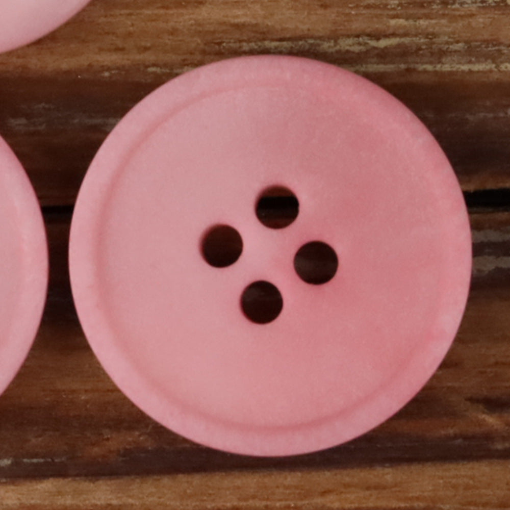 Pink round 4-hole matte natural nut button with four dark holes
