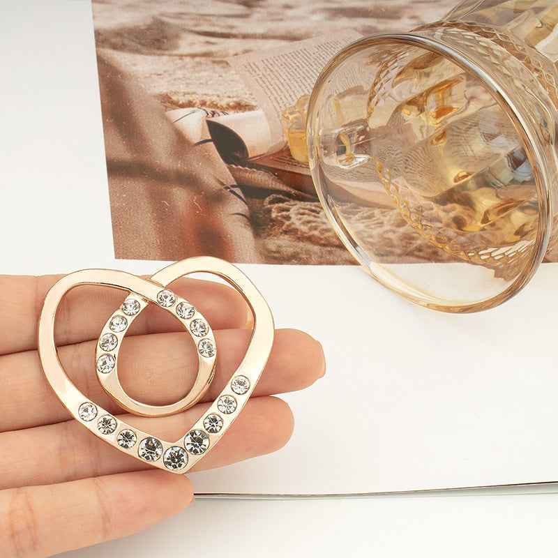 Heart-shaped rhinestone button, silver tone with round crystal stones
