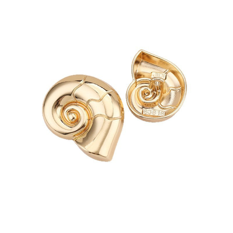 Snail-shaped metal shank button, light gold finish with spiral detail