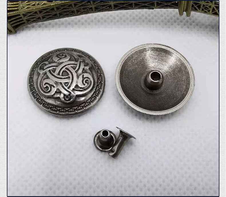 Round antique-silver cross rivet stud: embossed front, underside hole, and posts