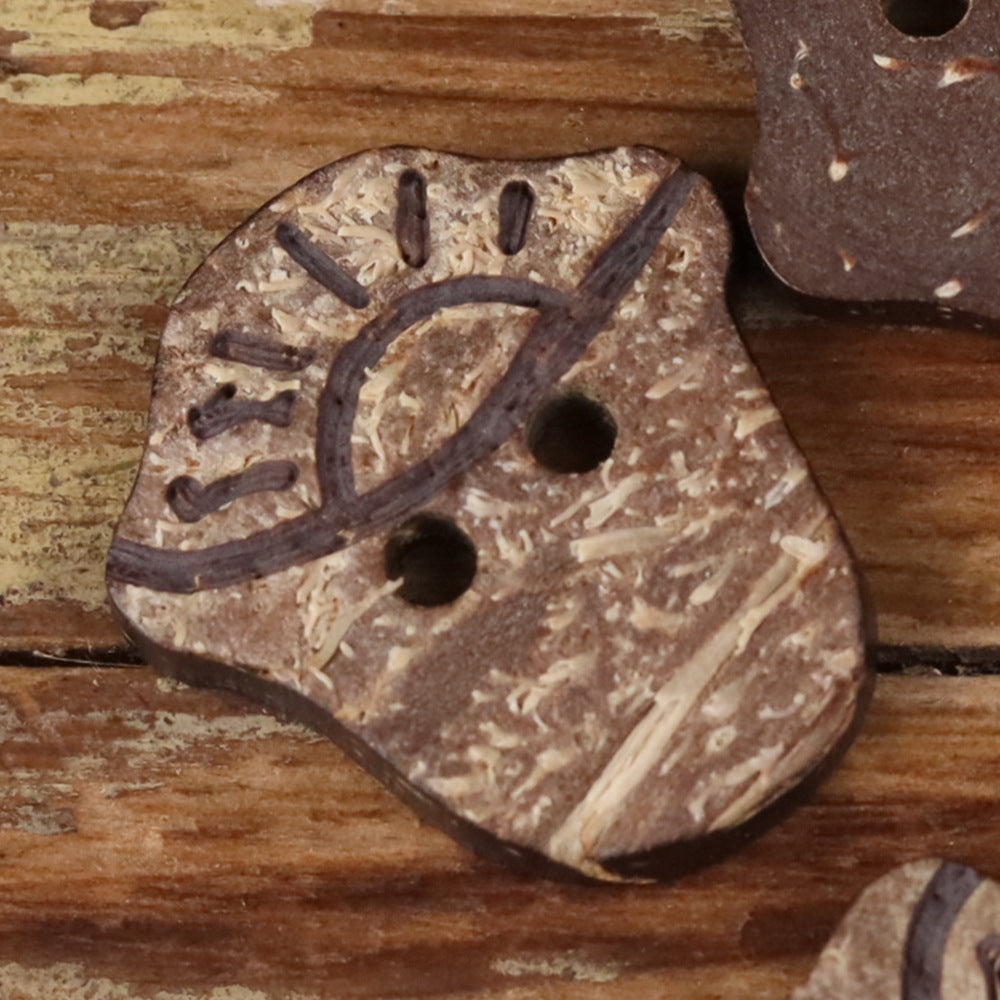 Coconut shell novelty button with two holes in a wagon-wheel shaped design