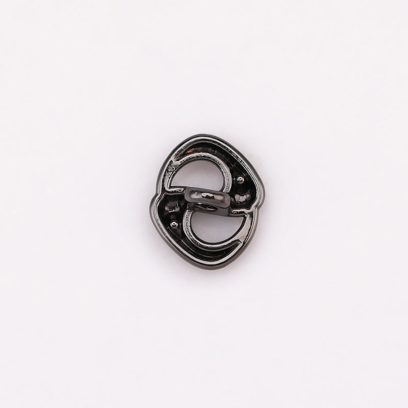 Silver-tone pig-nose rhinestone shank button, showing underside with metal shank posts